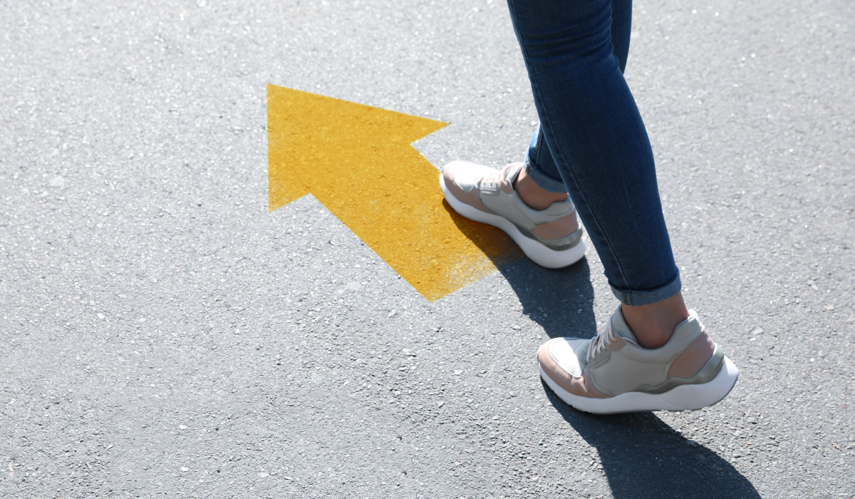 woman walking on an arrow