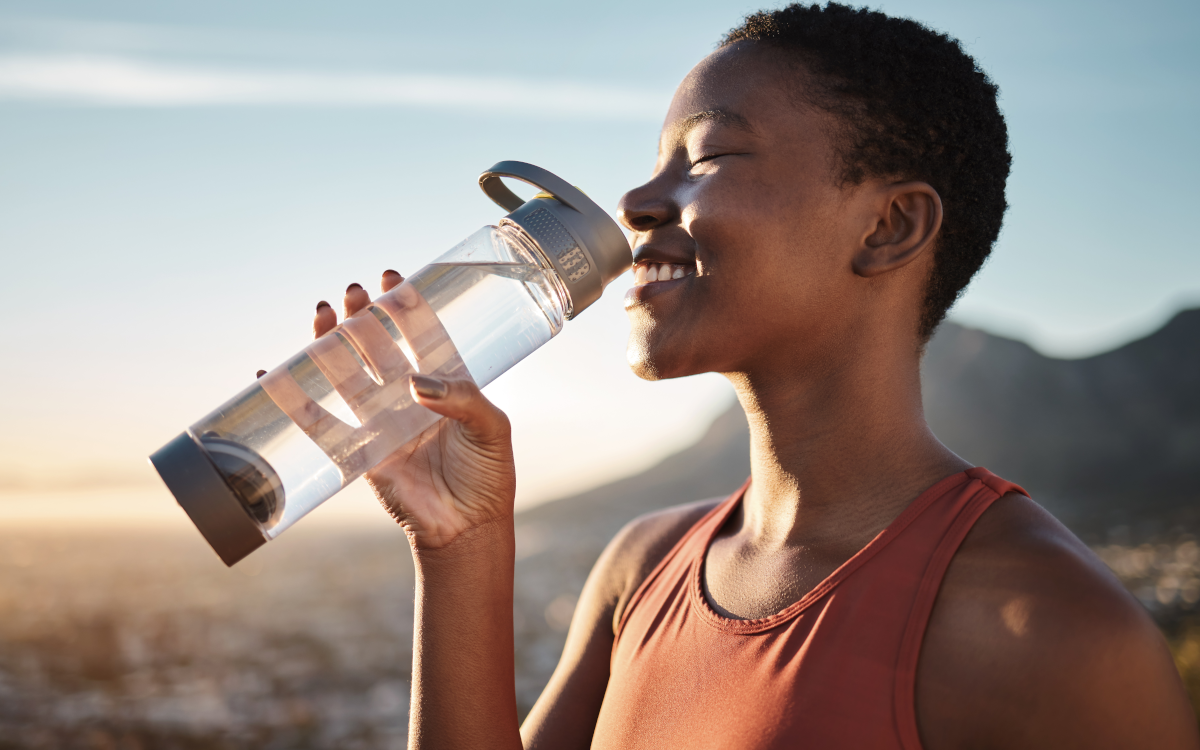 woman drinking water on hike